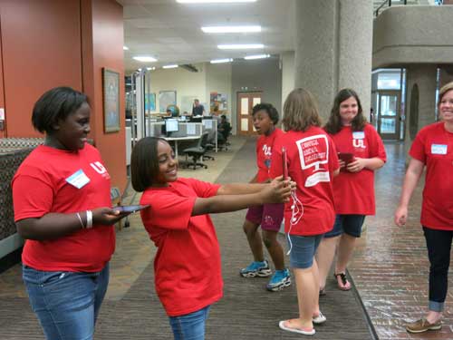 Girls take selfies in the library