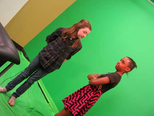 Girls prepare to shoot a greenscreen video