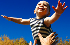 boy toddler being thrown into the air soaring.