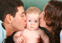 Man and woman kissing child