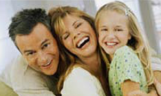 family where father is holding or protecting woman and child